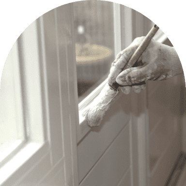 Painter restoring white window sill